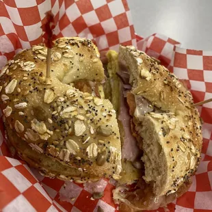 a bagel sandwich with a bite taken out of it