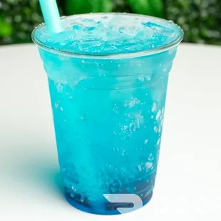 a blue drink with a straw