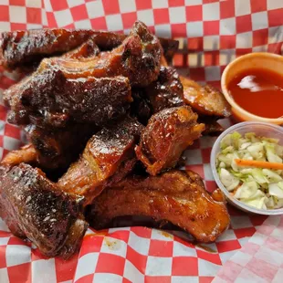 a basket of ribs and coleslaw