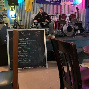 a man playing guitar in the background