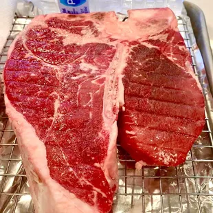 One 2.5 lb Porterhouse steak; water bottle for scale.