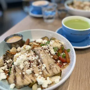 Warm chicken ancient grains bowl and Matcha Latte at Bluestone Lane Avery Cafe
