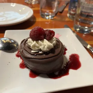 a chocolate dessert with raspberries on top