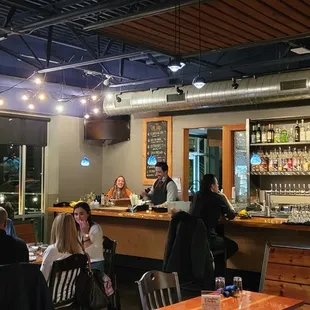 a group of people sitting at a bar