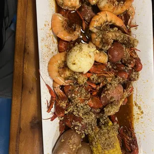 Crawfish, shrimp, potatoes, and corn with spicy garlic sauce.