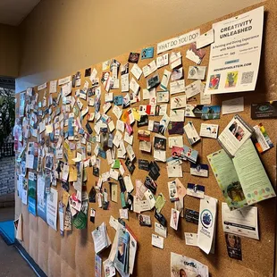 a cork board covered in post it notes