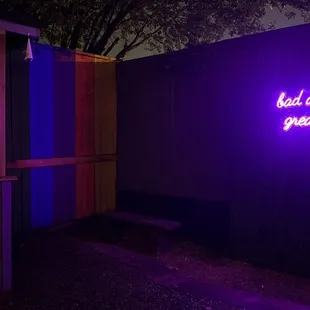 a purple neon sign in front of a building