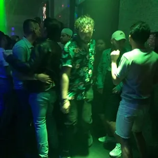 a group of people dancing in a club