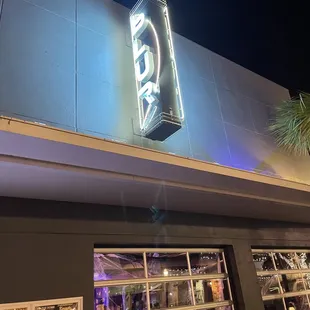 a neon sign on the side of a building