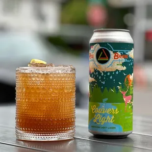 a can and a drink on a table
