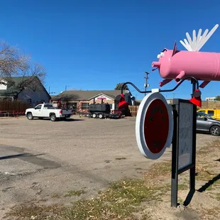 The building is set back from the road so just look for the pink pig.