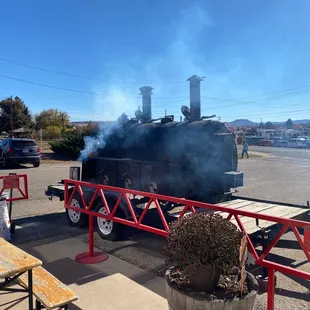 The smoker was busy making the meats for tomorrow.
