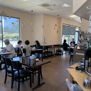 people sitting at tables in a restaurant