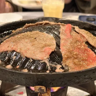 steaks being cooked in a skillet