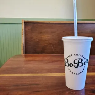 a plastic cup with a straw