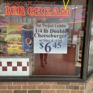 sign in the window for a 1/4 Cheeseburger meal for 6.45