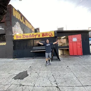 a man standing in front of a bbq