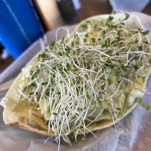 a taco with sprouts