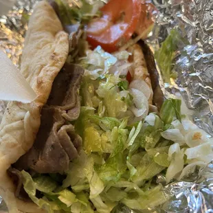 a pita sandwich with lettuce and tomatoes