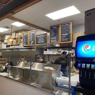 Friendly staff with menu above, you order on the left.