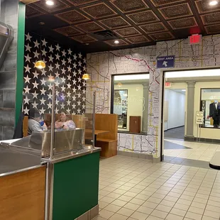 Seating by the first Ave stars, and cool map on the back wall. Entrance to the mall, where the bathrooms are located.