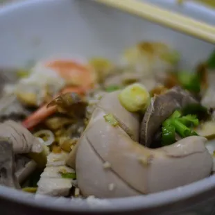 a bowl of food with chopsticks