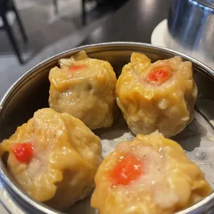 a metal container filled with dumplings