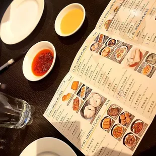 a table with a menu and plates of food