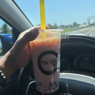 Strawberry green milk tea with blueberry popping pearls