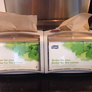 Napkin holders falsely representing care for post-consumer use of materials.