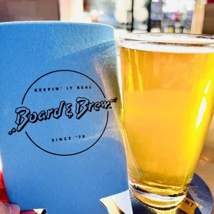 a hand holding a glass of beer