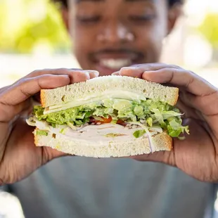 a man holding a sandwich