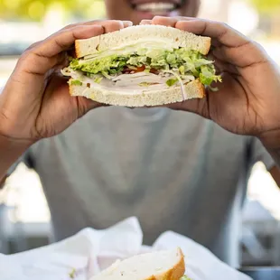 a man holding a sandwich