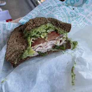 a turkey sandwich with lettuce and tomato