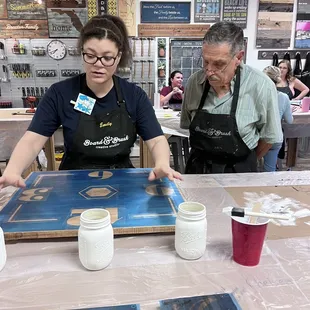 Table assistant explaining the stencil to my father