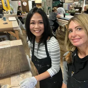 Me and the birthday girl after staining our wood sign