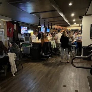 a group of people sitting at a bar
