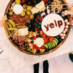 a platter of fruit, cheese, crackers, and crackers