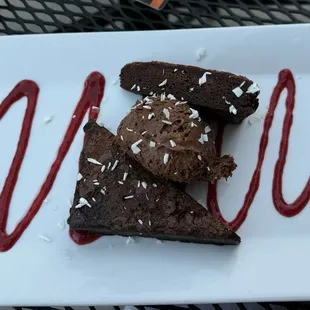 Chocolate brownie with chocolate mousse and raspberry swirl. Super rich.