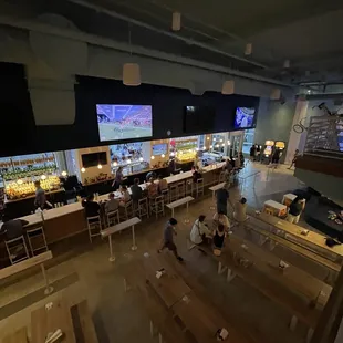 people sitting at tables and watching tvs