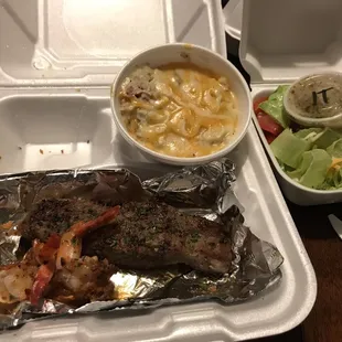 Steak and shrimp with twice baked potato and salad