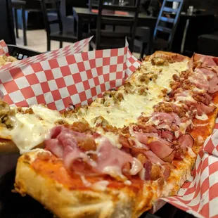 a slice of pizza with meat and cheese