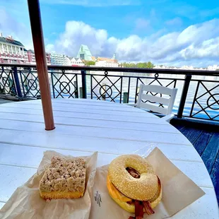 two sandwiches and a bagel on a table