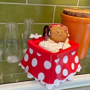 a cupcake in a polka dot container