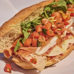 a sub sandwich on a white plate