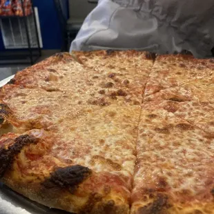 a large pizza on a silver platter