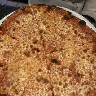 a cheese pizza on a white plate