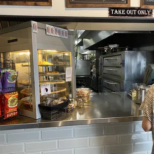 a woman standing in front of a counter