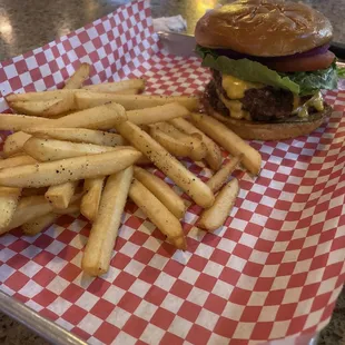 a burger and fries on a tray