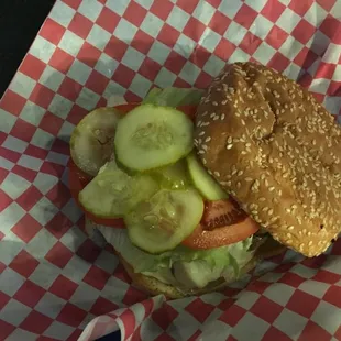a hamburger with pickles and tomatoes